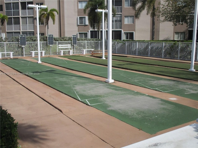 surrounding community with shuffleboard and fence