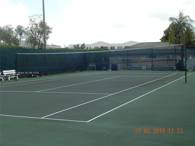 view of tennis court with fence