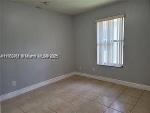 tiled empty room with baseboards