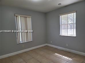 tiled empty room with baseboards