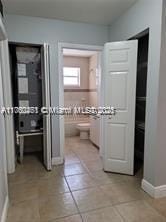 hallway with light tile patterned floors