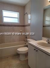 full bathroom with tile patterned floors, toilet, vanity, and  shower combination