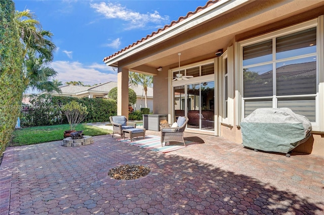 view of patio with a grill and an outdoor fire pit