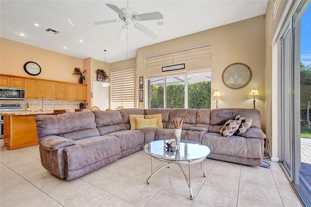 living area featuring light tile patterned flooring, recessed lighting, visible vents, and ceiling fan