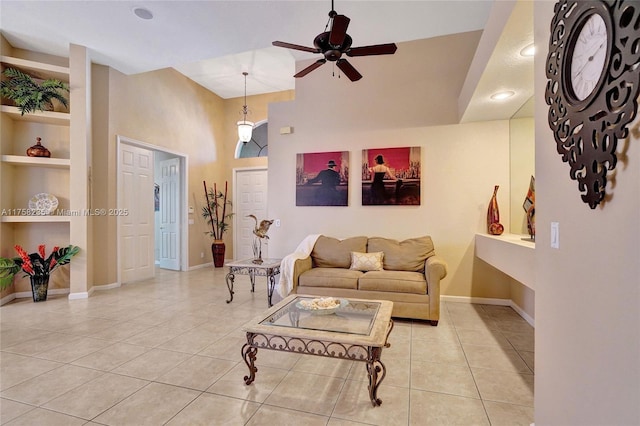 living area with built in features, baseboards, a ceiling fan, and light tile patterned floors