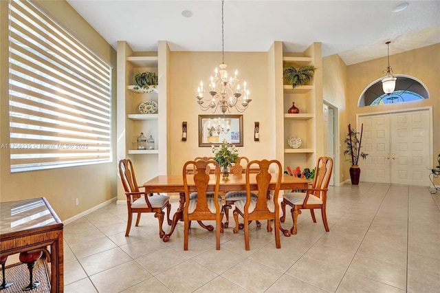 dining space featuring built in features, baseboards, a notable chandelier, and light tile patterned floors