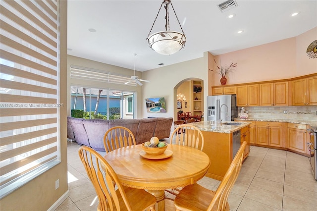 dining room with visible vents, recessed lighting, arched walkways, light tile patterned floors, and ceiling fan