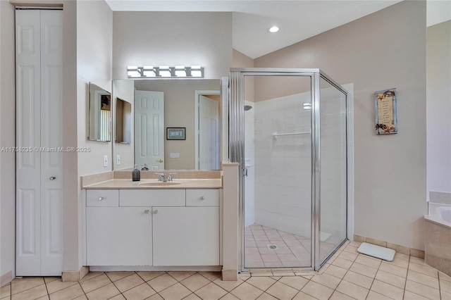 bathroom featuring tile patterned floors, vanity, a bath, and a shower stall