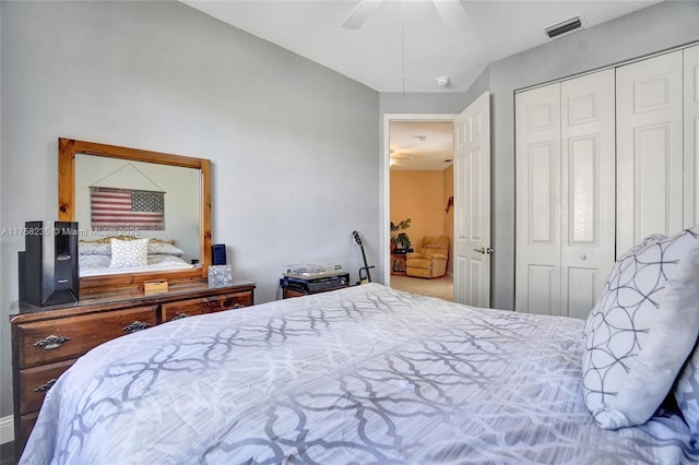 bedroom with a ceiling fan, visible vents, and a closet