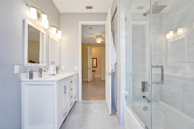 bathroom with visible vents, ceiling fan, double vanity, combined bath / shower with glass door, and a sink