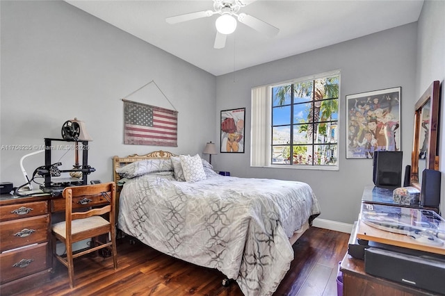 bedroom with a ceiling fan, wood finished floors, and baseboards