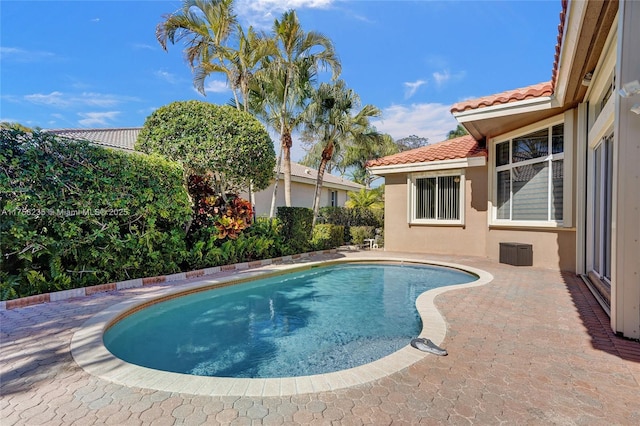 outdoor pool with a patio area