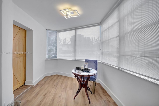 living area featuring baseboards and wood finished floors