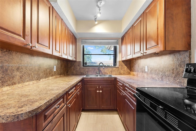 1311 N 19th Ave, Hollywood, FL 33020 - kitchen with black / electric stove, a sink, tasteful backsplash, and brown cabinets
