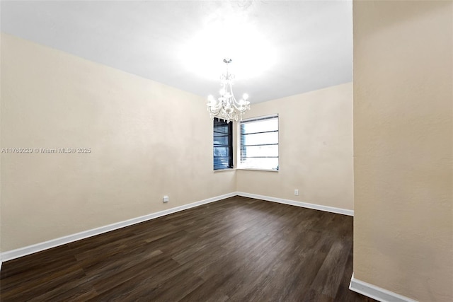 1311 N 19th Ave, Hollywood, FL 33020 - empty room with a chandelier, dark wood-style flooring, and baseboards