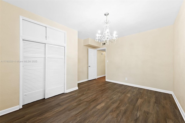 1311 N 19th Ave, Hollywood, FL 33020 - unfurnished dining area featuring a chandelier, dark wood-type flooring, and baseboards