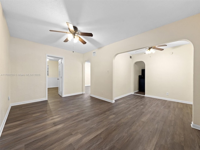 1311 N 19th Ave, Hollywood, FL 33020 - unfurnished living room featuring a ceiling fan, arched walkways, dark wood-style flooring, and baseboards