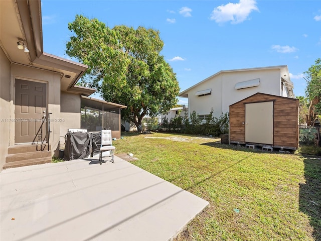 1311 N 19th Ave, Hollywood, FL 33020 - view of grassy yard featuring a storage unit, a patio, an outdoor structure, a sunroom, and entry steps