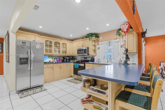 kitchen with visible vents, open shelves, a peninsula, stainless steel appliances, and dark countertops