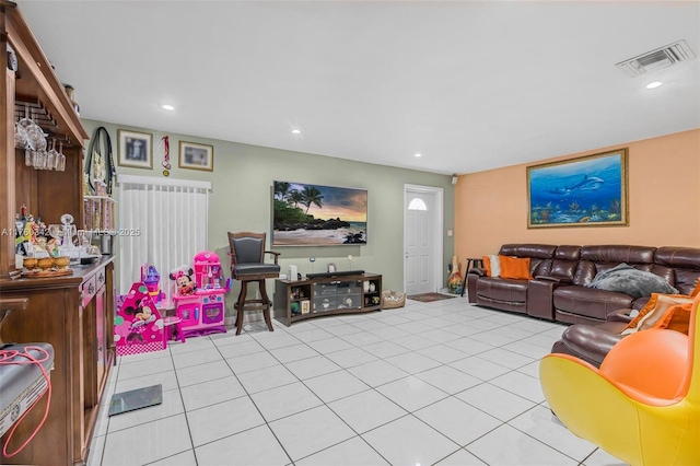 living area with light tile patterned flooring, recessed lighting, and visible vents