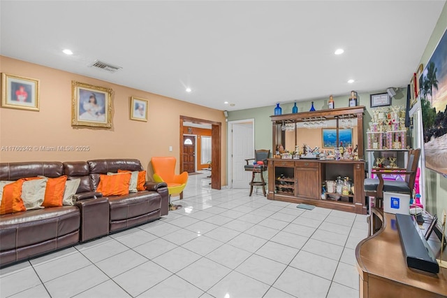 living room featuring light tile patterned floors, visible vents, and recessed lighting