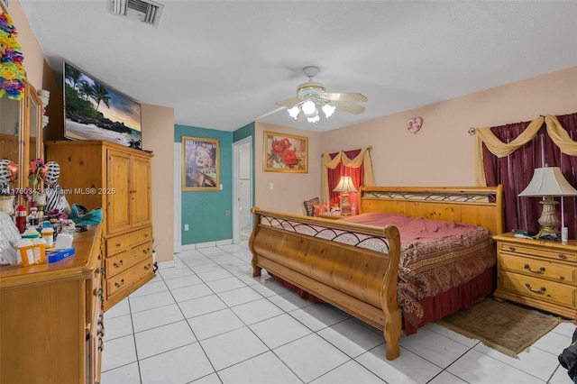 bedroom featuring light tile patterned floors, visible vents, and ceiling fan