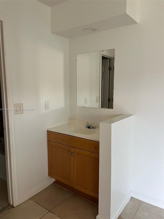 bathroom with vanity, tile patterned floors, and baseboards