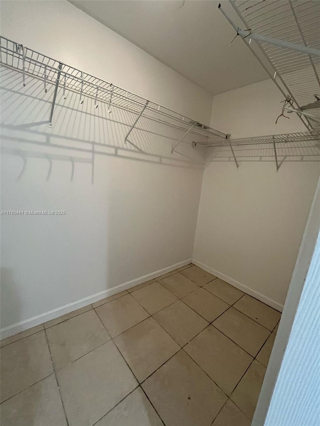 walk in closet featuring tile patterned flooring