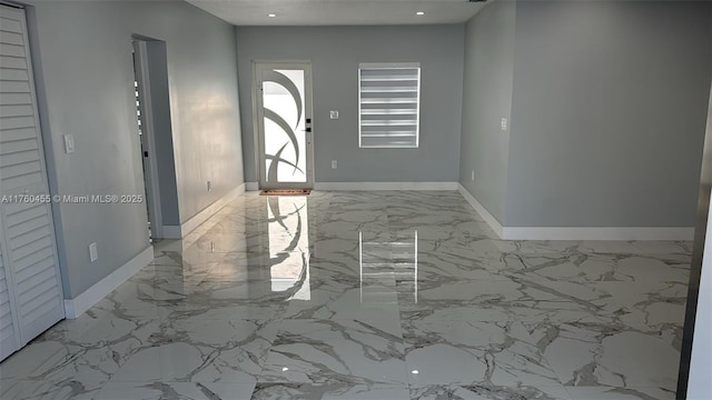 entrance foyer with recessed lighting, marble finish floor, and baseboards