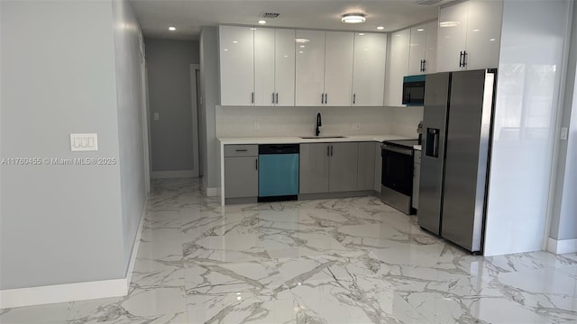 kitchen featuring a sink, marble finish floor, appliances with stainless steel finishes, and light countertops