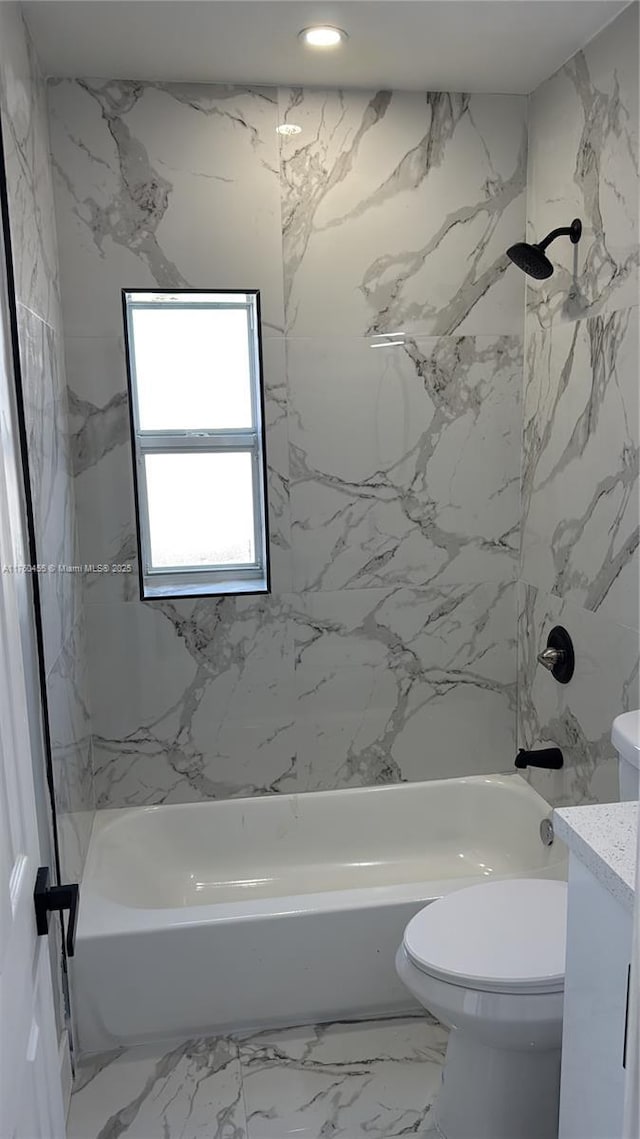 bathroom featuring vanity, toilet, washtub / shower combination, and marble finish floor