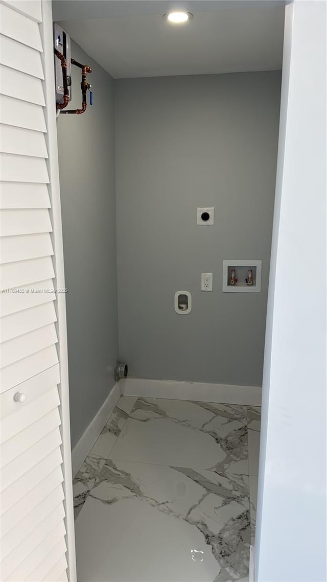 laundry area with electric dryer hookup, washer hookup, marble finish floor, baseboards, and laundry area