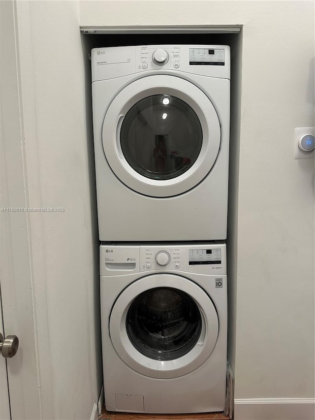 clothes washing area featuring laundry area and stacked washer / dryer