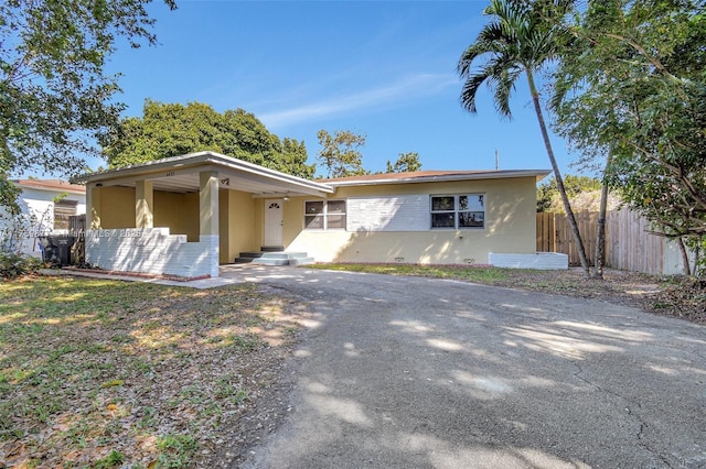 view of front of property with stucco siding and fence