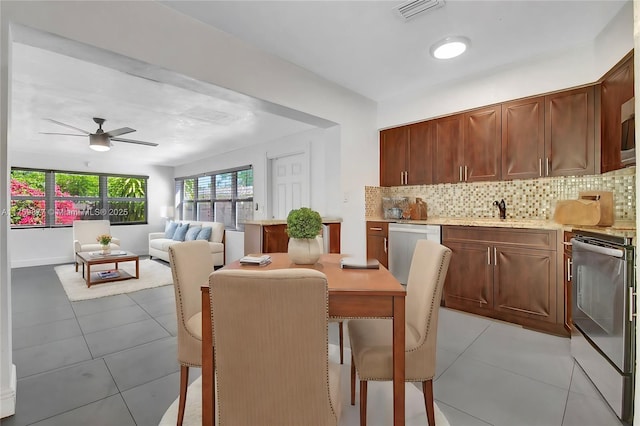 dining room featuring light tile patterned floors, visible vents, and a ceiling fan