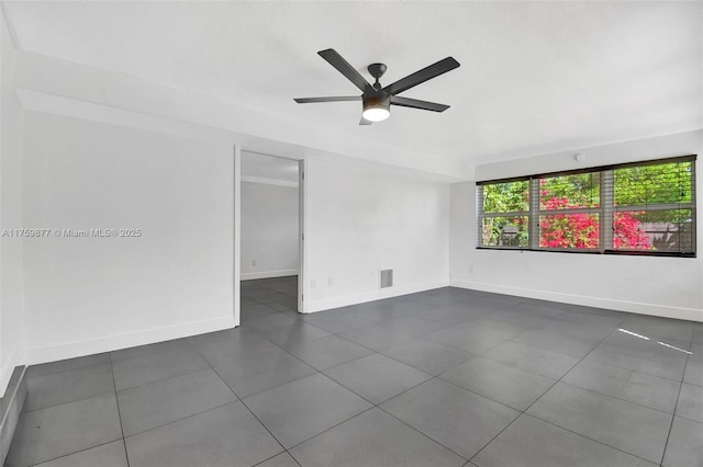 unfurnished room featuring a ceiling fan, visible vents, and baseboards