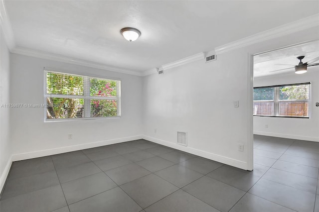 unfurnished room with a ceiling fan, crown molding, baseboards, and visible vents