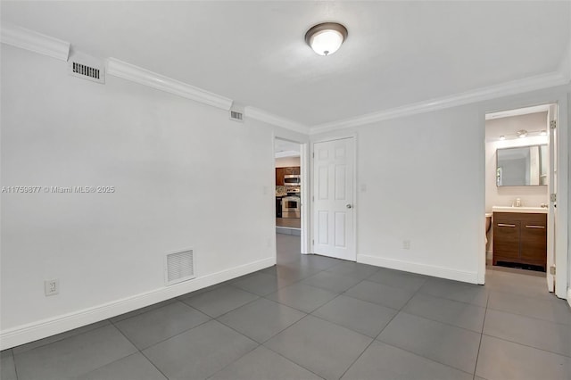 unfurnished room with visible vents, baseboards, and ornamental molding