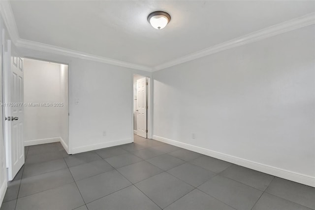 empty room with baseboards and ornamental molding