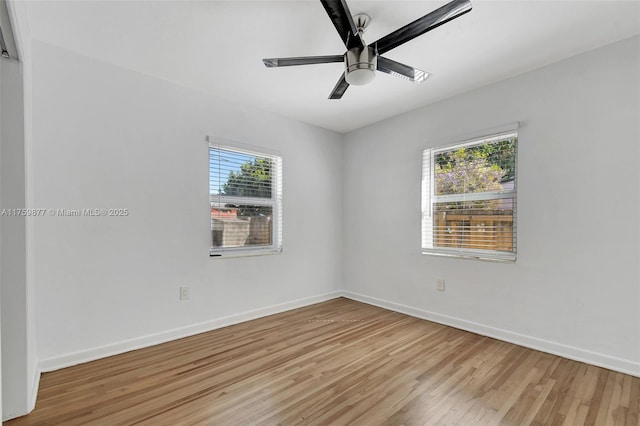 unfurnished room with baseboards, a ceiling fan, and light wood finished floors