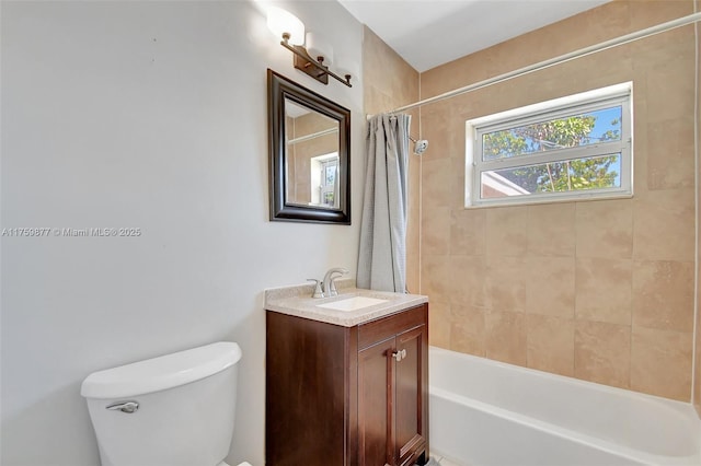 bathroom featuring toilet, shower / bath combo with shower curtain, and vanity