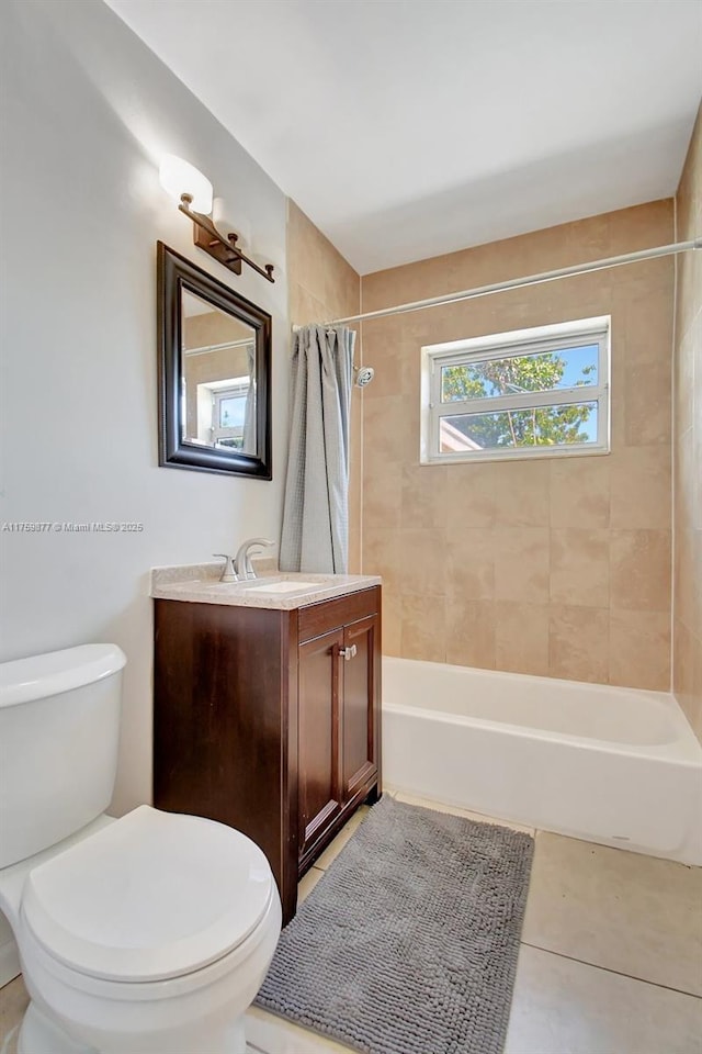 bathroom featuring tile patterned floors, toilet, vanity, and shower / bathtub combination with curtain