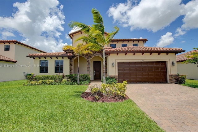 mediterranean / spanish house featuring stucco siding, an attached garage, and a front lawn