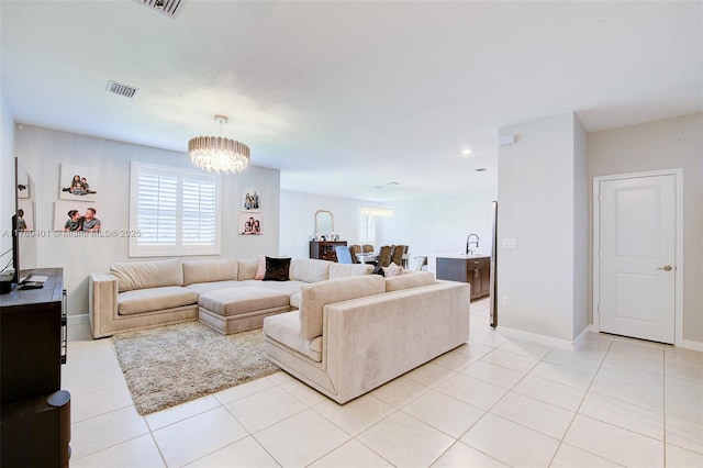 living area featuring light tile patterned floors, baseboards, visible vents, recessed lighting, and a notable chandelier