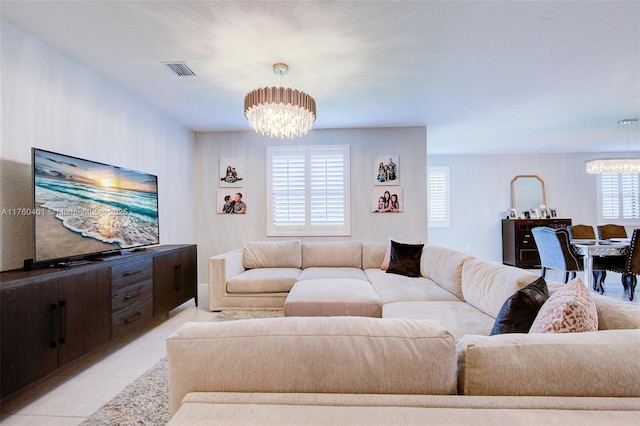 living area featuring light tile patterned floors, visible vents, and a chandelier