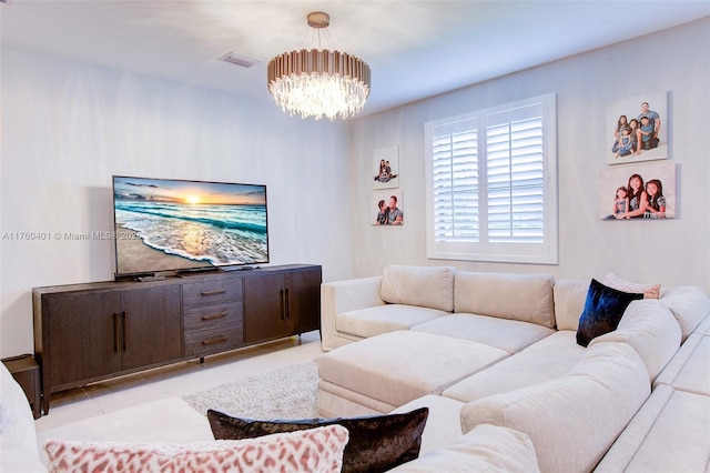 living room with tile patterned flooring, visible vents, and an inviting chandelier