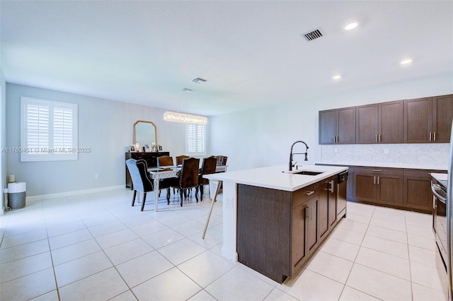 kitchen featuring visible vents, a sink, light countertops, light tile patterned floors, and dishwasher