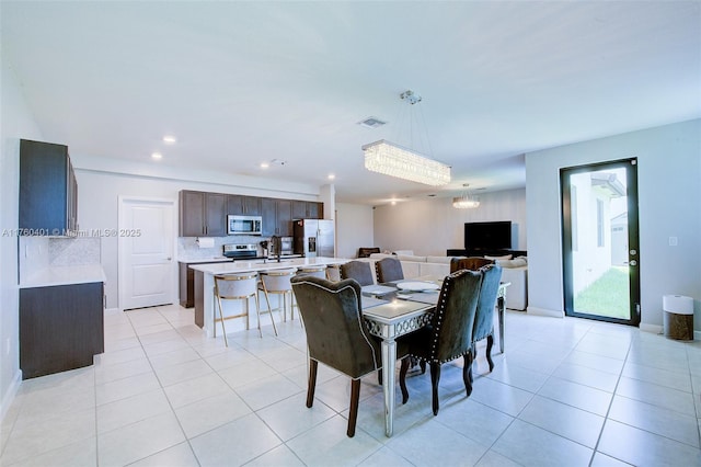 dining area with light tile patterned floors, visible vents, recessed lighting, and baseboards