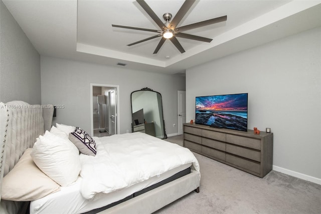 bedroom featuring visible vents, baseboards, connected bathroom, carpet, and a raised ceiling