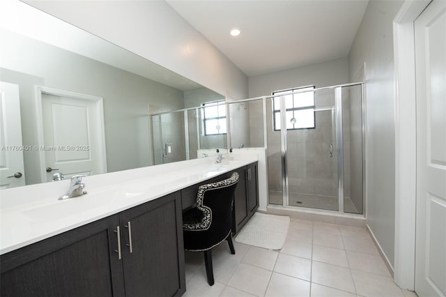 full bathroom with a sink, double vanity, a shower stall, and tile patterned flooring